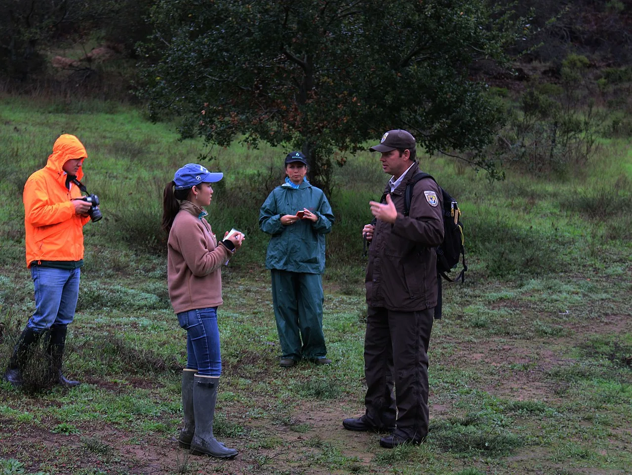 A journalist interviewing wildlife-service staff in the field