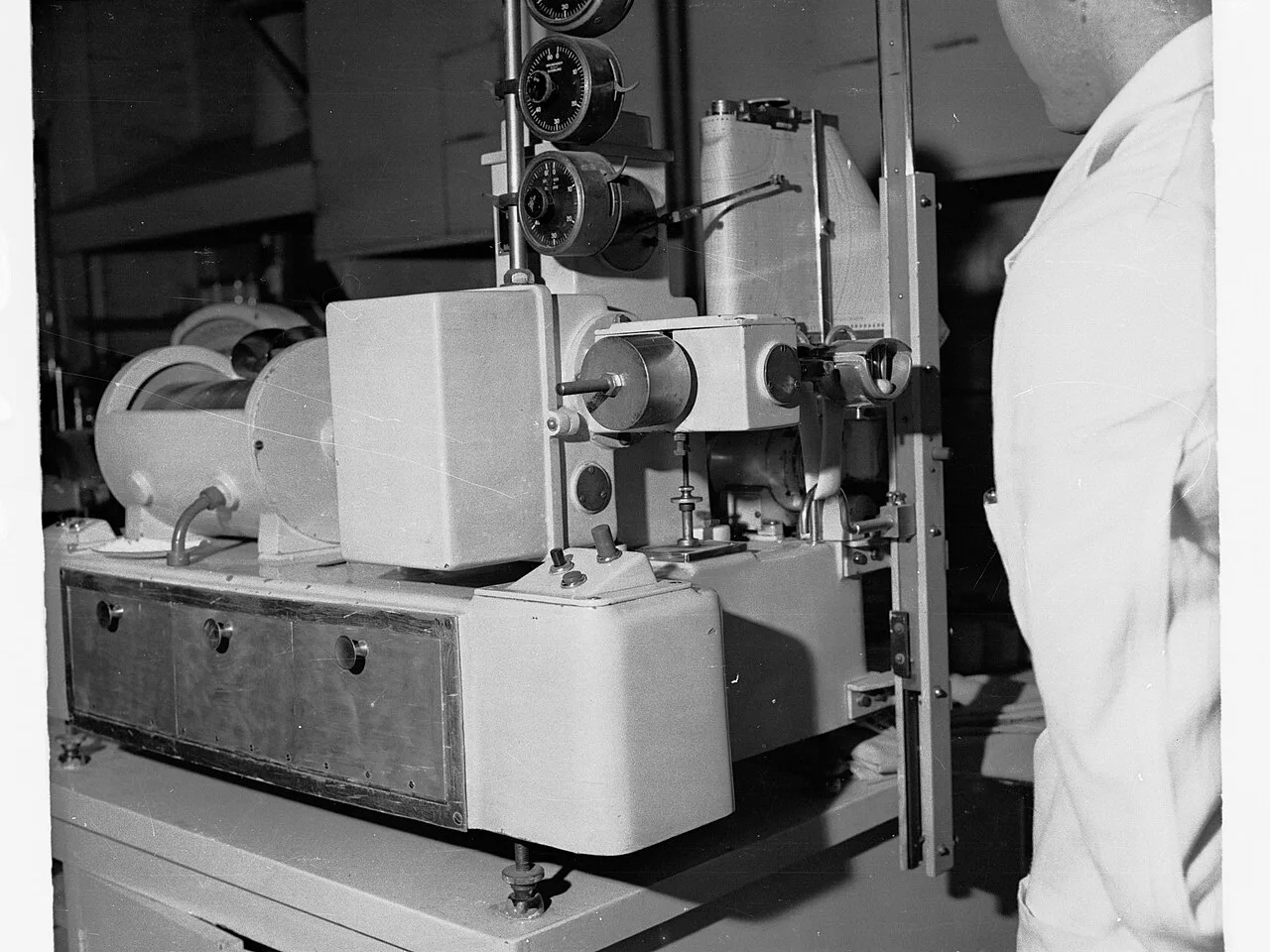 A scientist working beside laboratory equipment around 1945