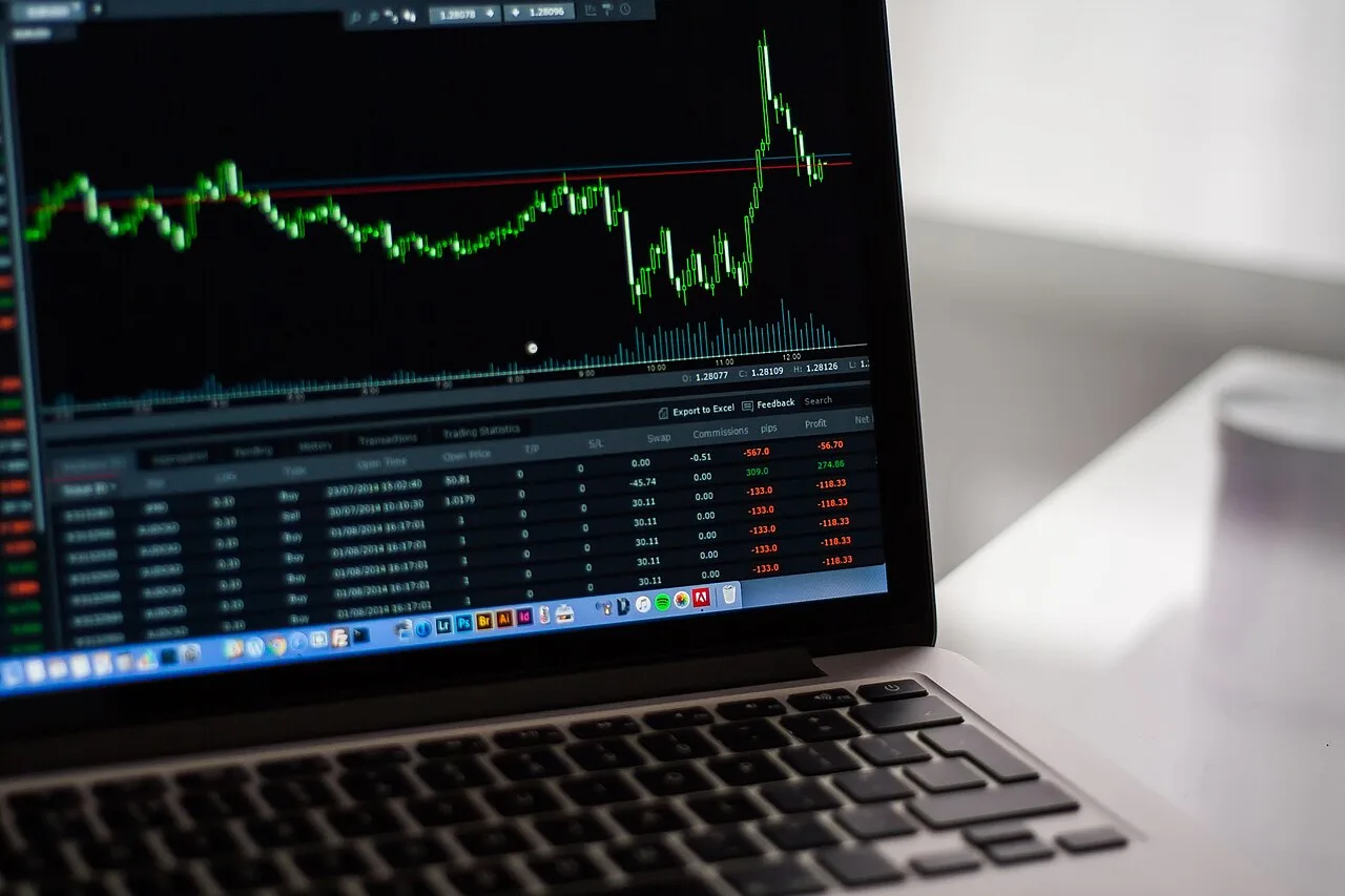 A laptop displaying a financial market chart and numerical data